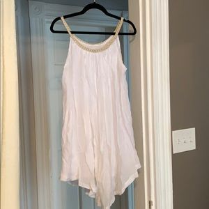 White dress with gold neckline detail.